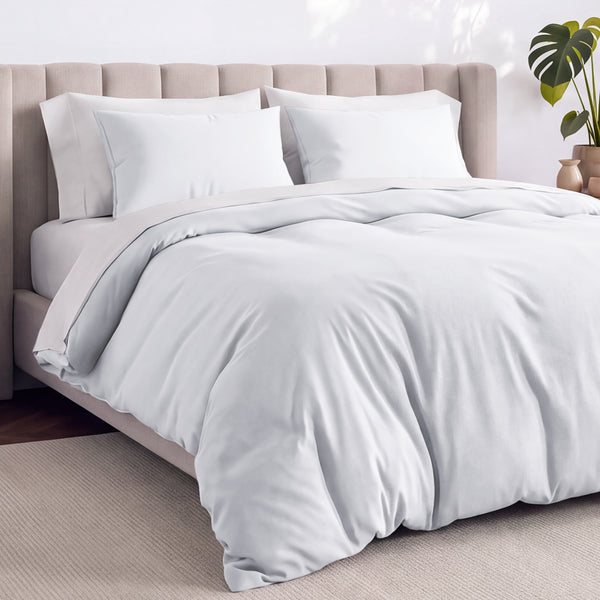 Bed with jersey duvet set against a beige headboard.