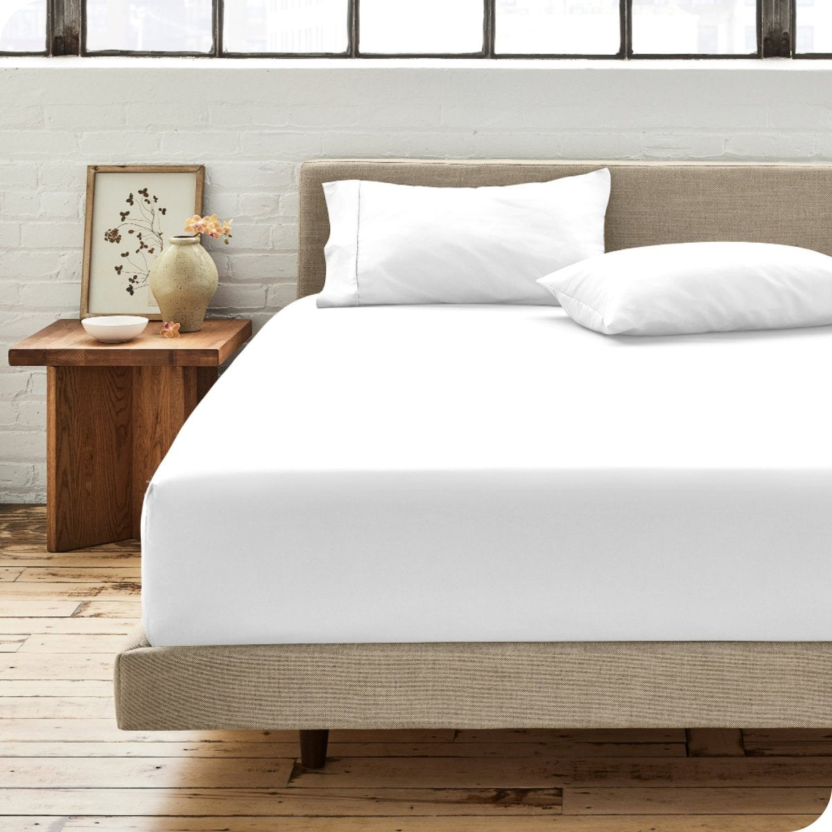 Modern bedroom with bed showing percale fitted sheet