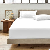 Modern bedroom with bed showing percale fitted sheet