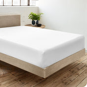 Diagonal view of room scene with percale fitted sheet on the bed