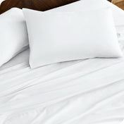 Close up of percale pillowcases and sheets on a bed