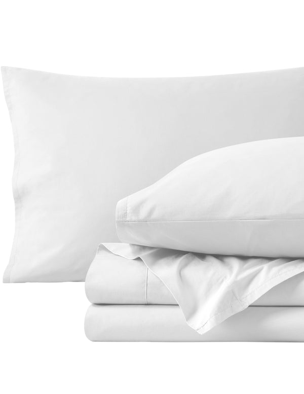 Percale sheets folded and matching pillowcases with pillows in them