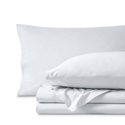 Percale bedding set including pillowcases and folded sheets arranged on a clean white background