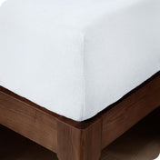 Close up of the corner of a mattress with a fleece fitted sheet on it
