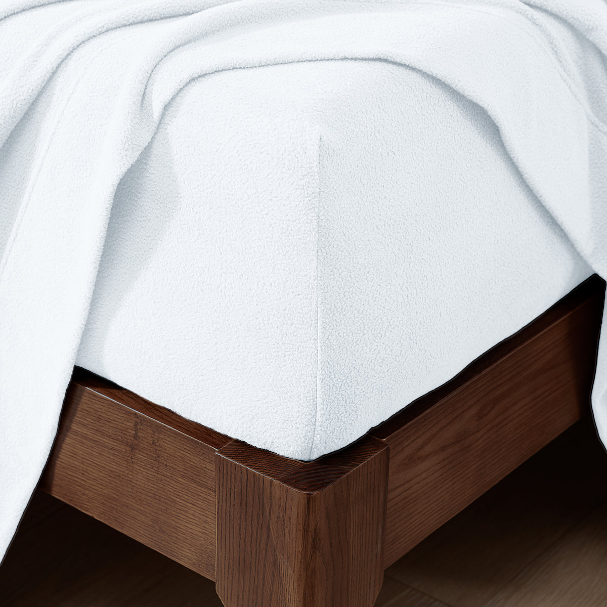Fitted sheet on a wooden bed frame