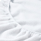Close up of the elastic portion of a fleece fitted sheet