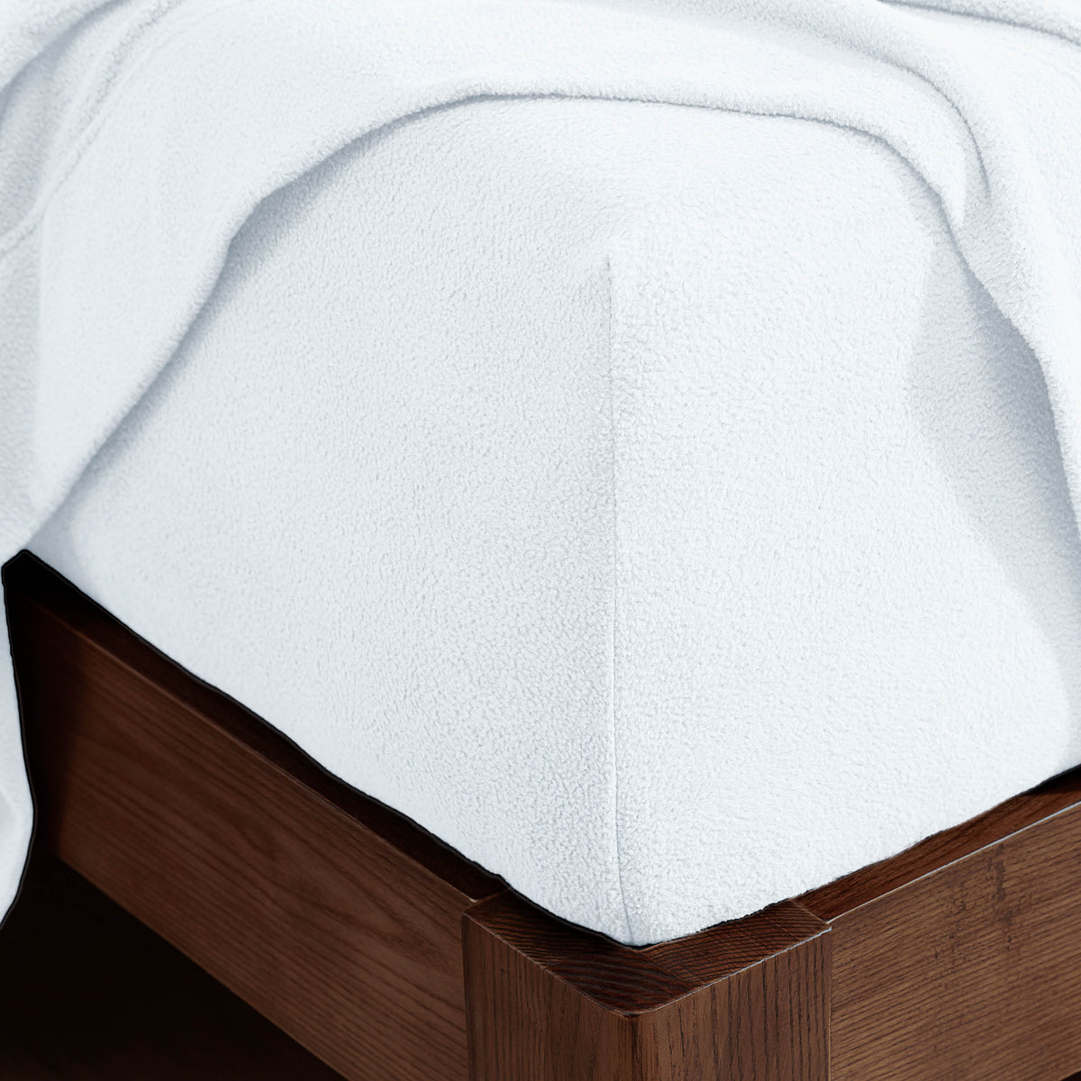 Corner of a mattress with a fitted sheet on it
