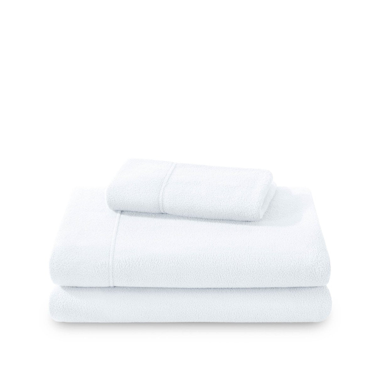 Polar fleece sheets and pillowcases folded and stacked on a white background
