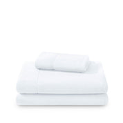 Polar fleece sheets and pillowcases folded and stacked on a white background