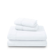 Polar fleece sheets and pillowcases folded and stacked on a white background
