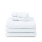 Polar fleece sheets and pillowcases folded and stacked on a white background