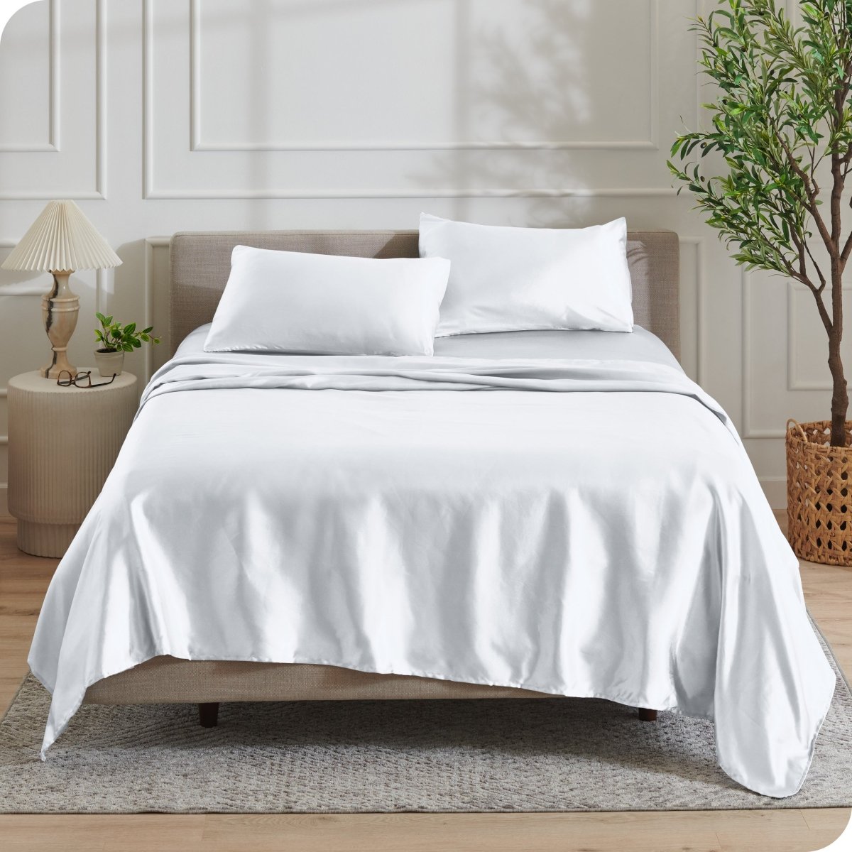Satin sheets draped over a mattress