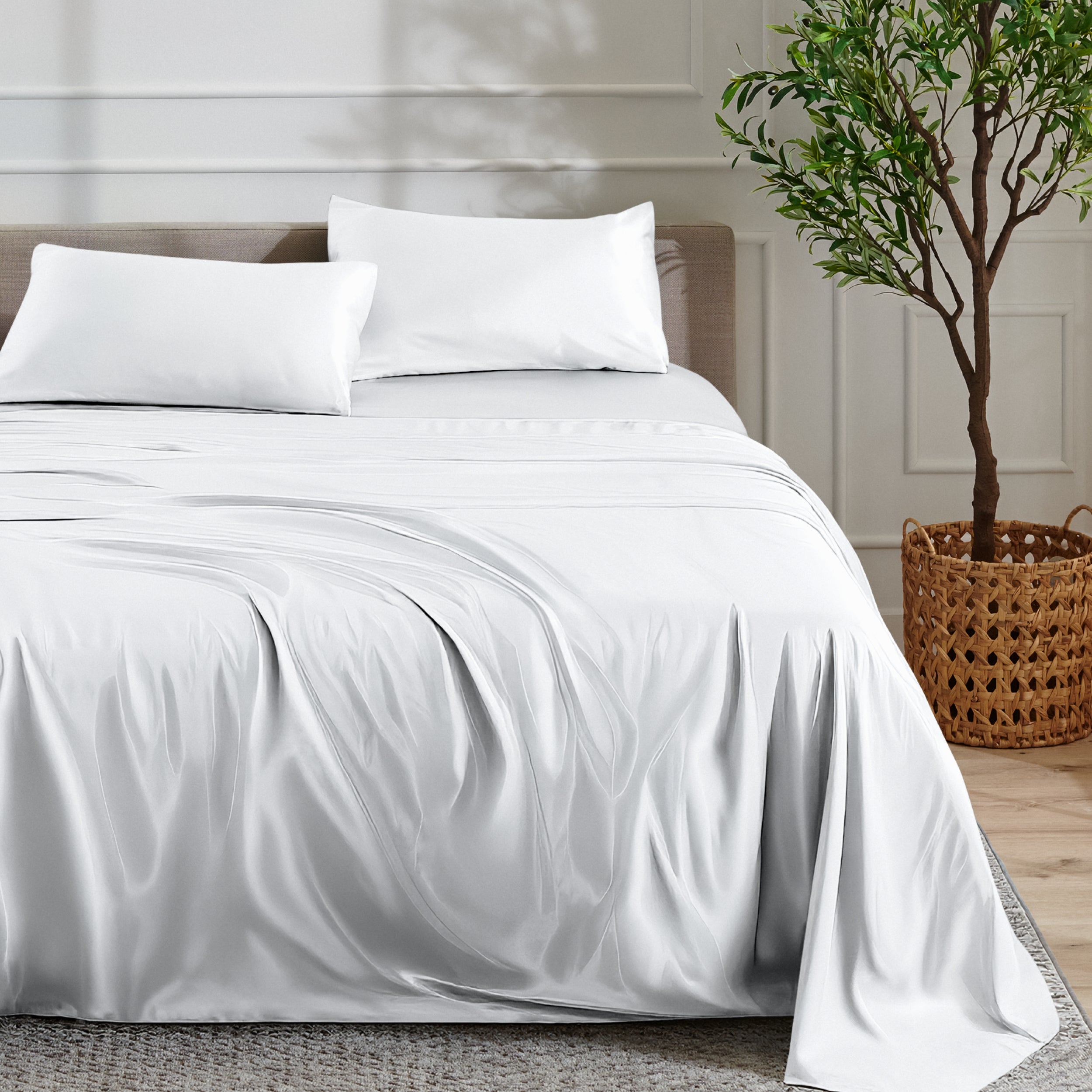Satin sheet set on a bed with a plant and basket in the background