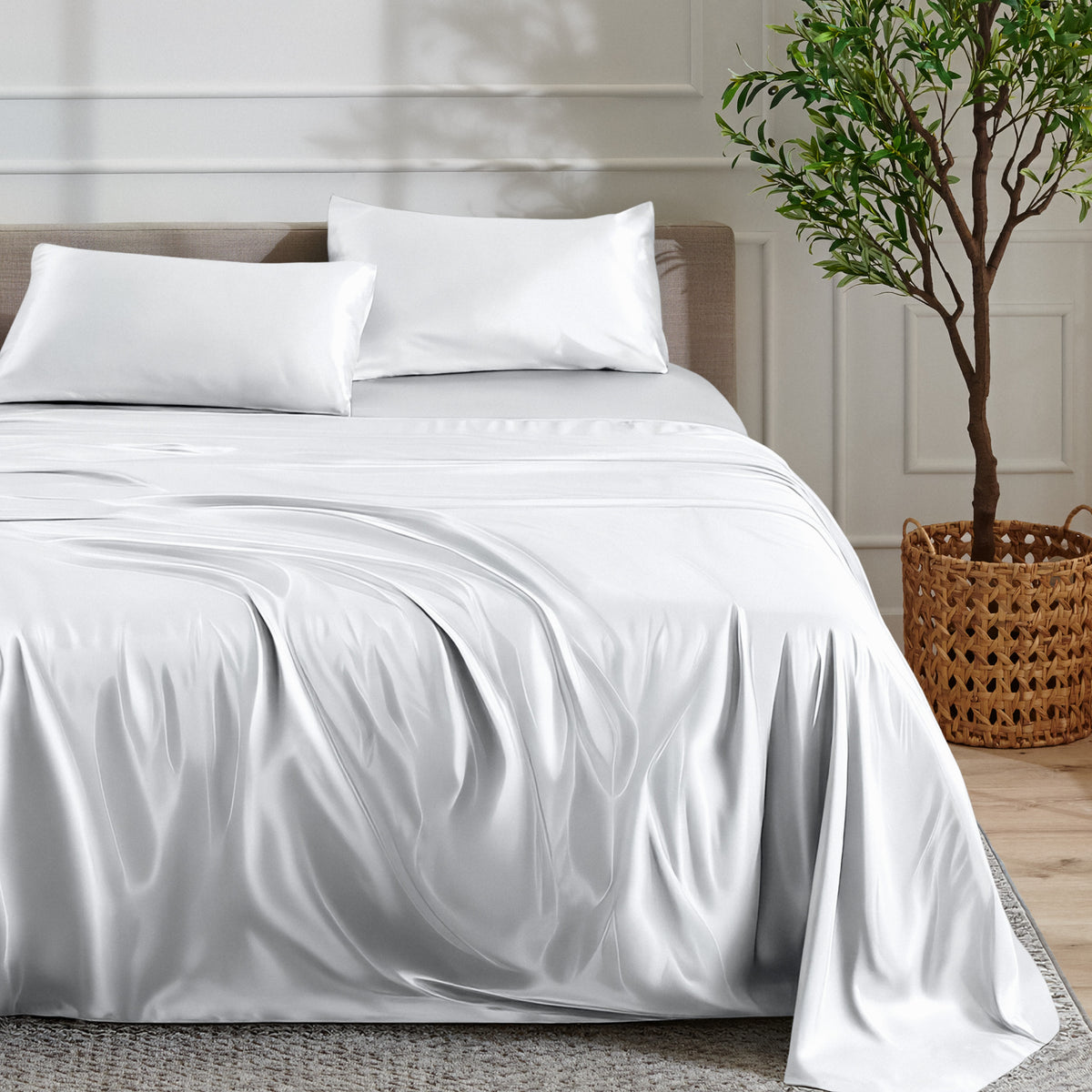 Satin sheet set on a bed with a plant and basket in the background