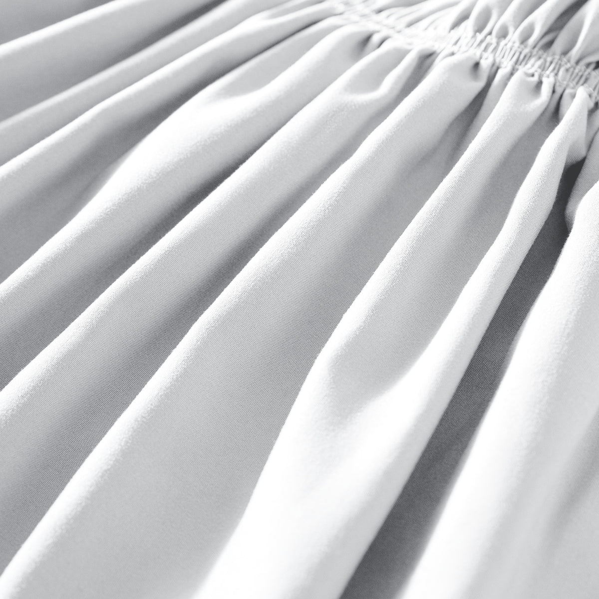 Close-up of polyester bed skirt fabric with a focus on texture and folds.