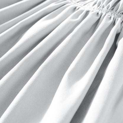 Close-up of polyester bed skirt fabric with a focus on texture and folds.