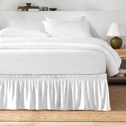 Bed with white bedding and a bed skirt.