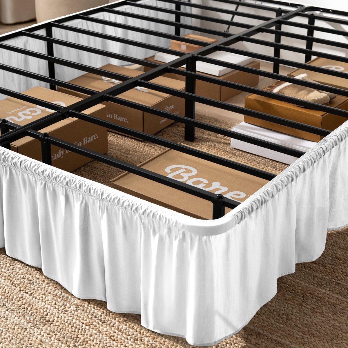Bed frame with bed skirt and Bare Home boxes underneath.