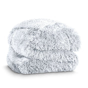 A shaggy faux fur blanket folded