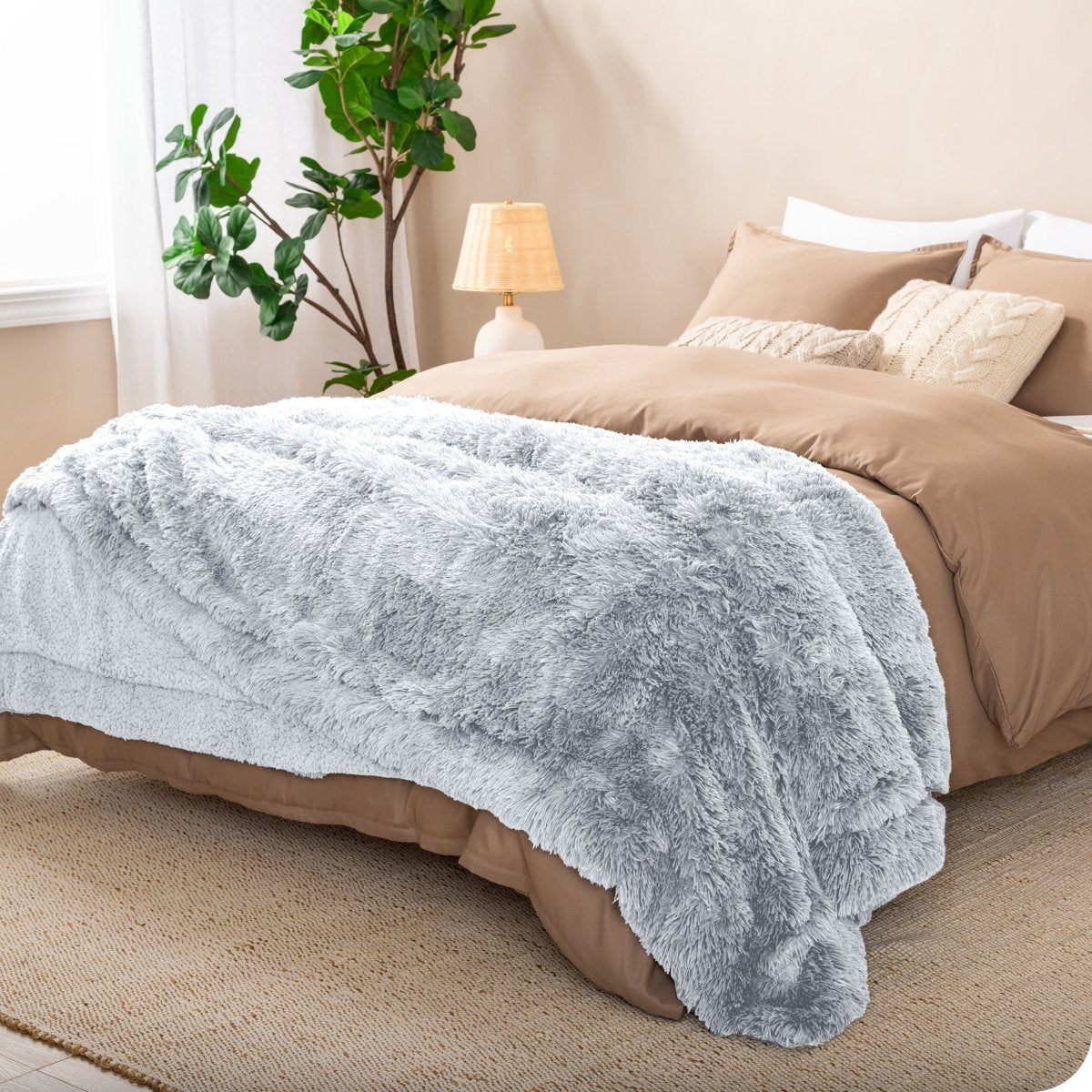 A shaggy faux fur blanket on the end of a bed