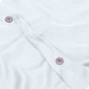 Close up of the buttons on a TENCEL™ duvet cover