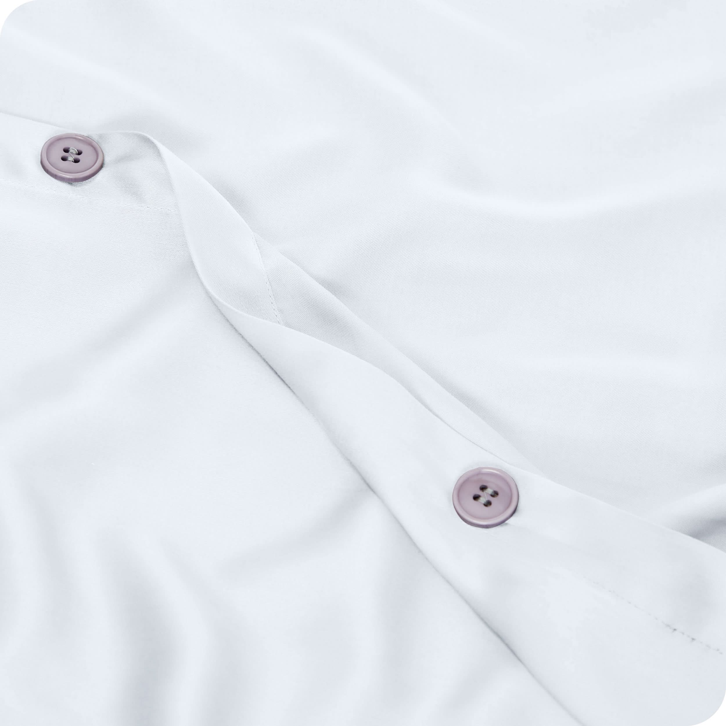 Close up of the buttons on a TENCEL™ duvet cover