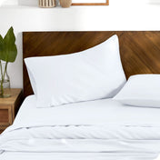 TENCEL™ pillowcases on pillows. One pillow is leaning against the headboard while the other is flat on the mattress.