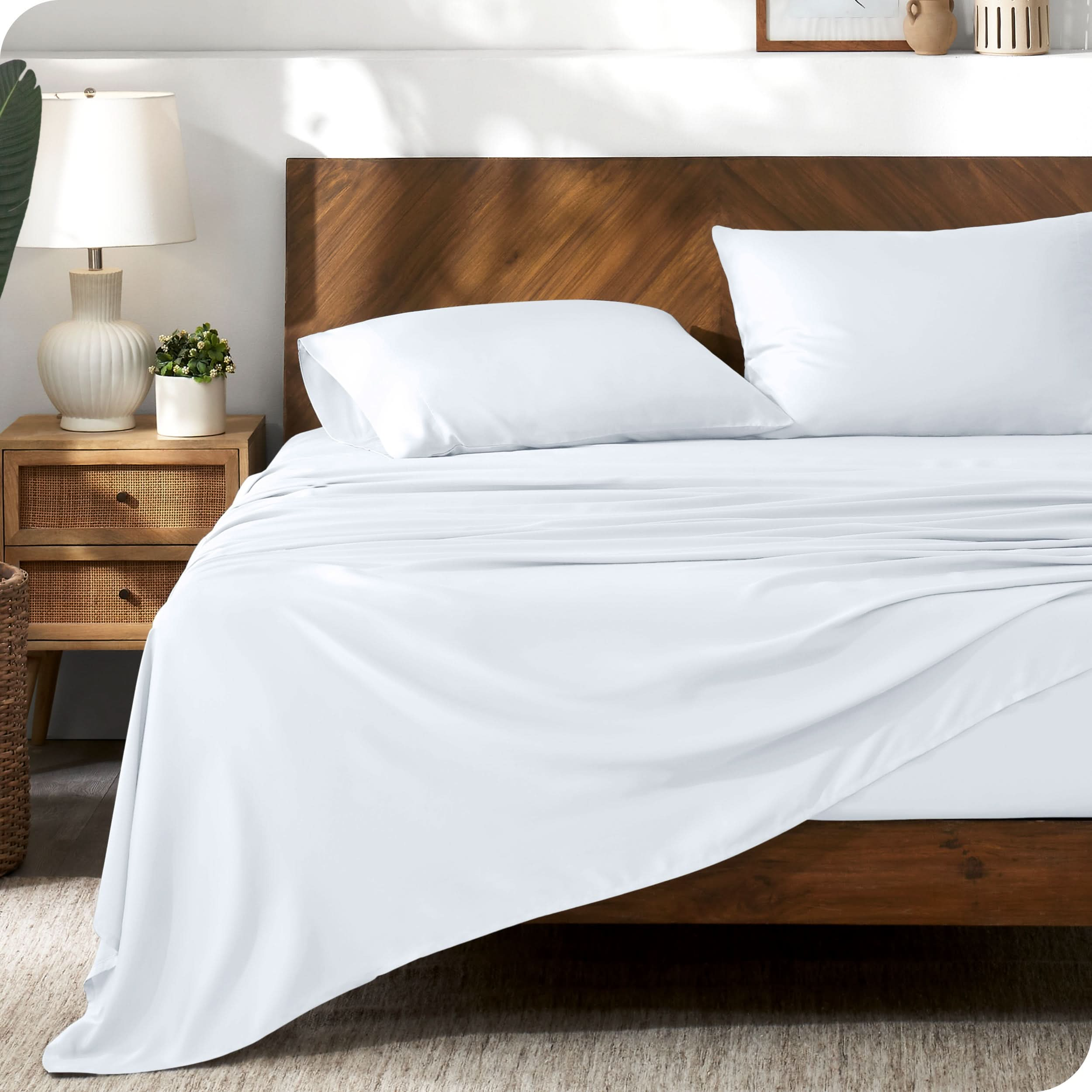 TENCEL™ sheet set on a bed. The flat sheet is draped over the side and end of the bed.