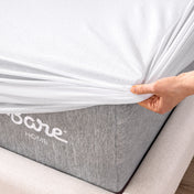 Close up of the corner of a mattress with a mattress protector being put on it