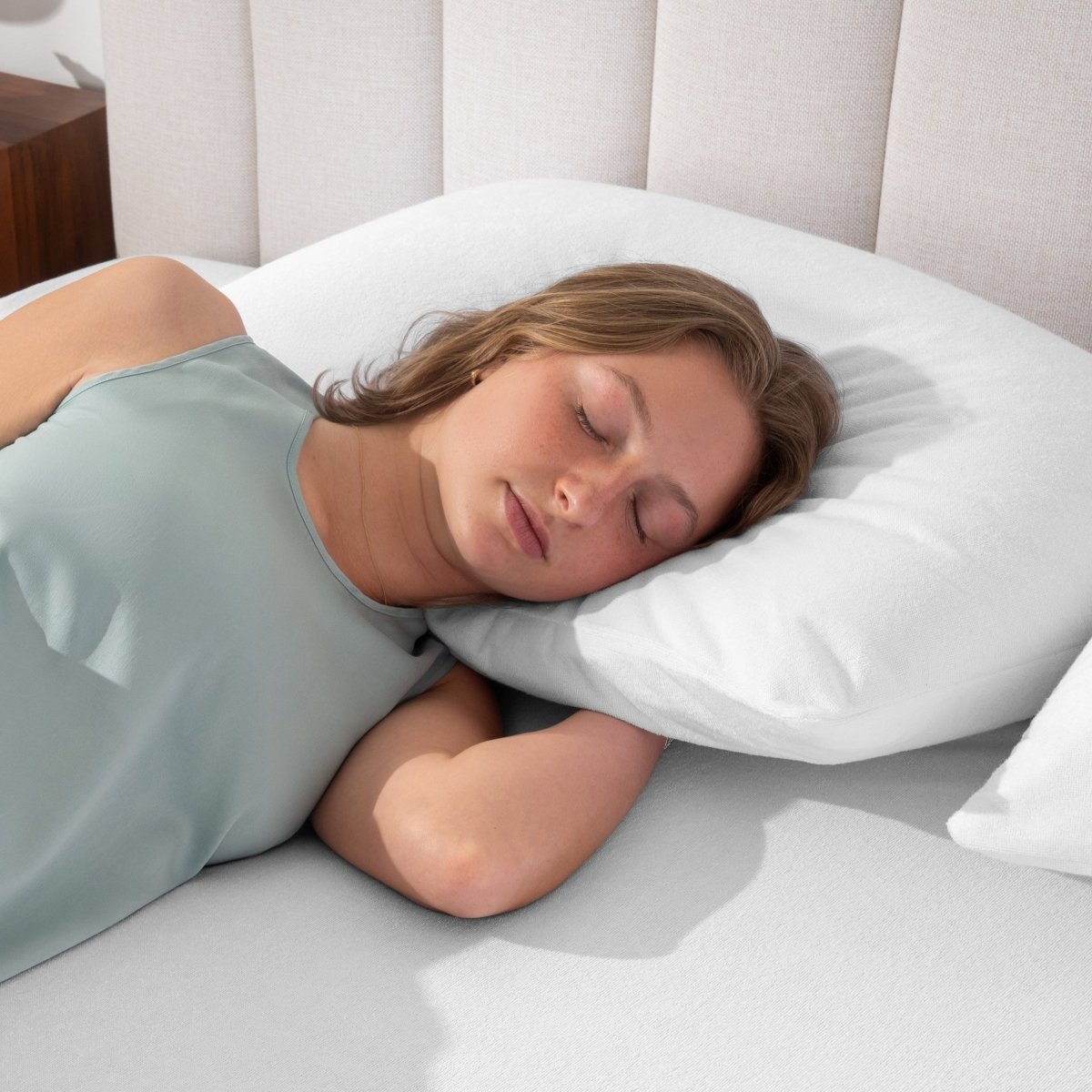 A woman is sleeping with her head on a pillow