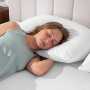 A woman is sleeping with her head on a pillow