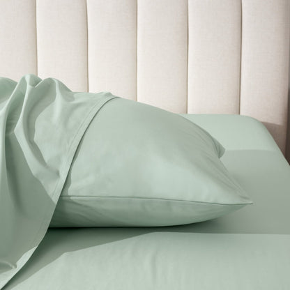 Pillow on a bed with a neutral headboard