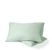 Two pillows with percale pillowcases on them