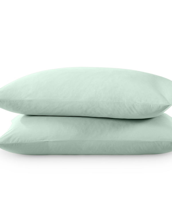 Two pillows with percale pillowcases on them