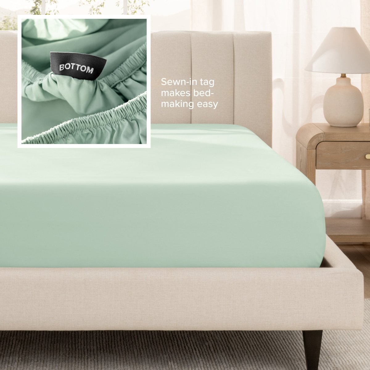 Sateen fitted sheet on a bed with a close-up of a sewn-in tag, set in a bedroom.