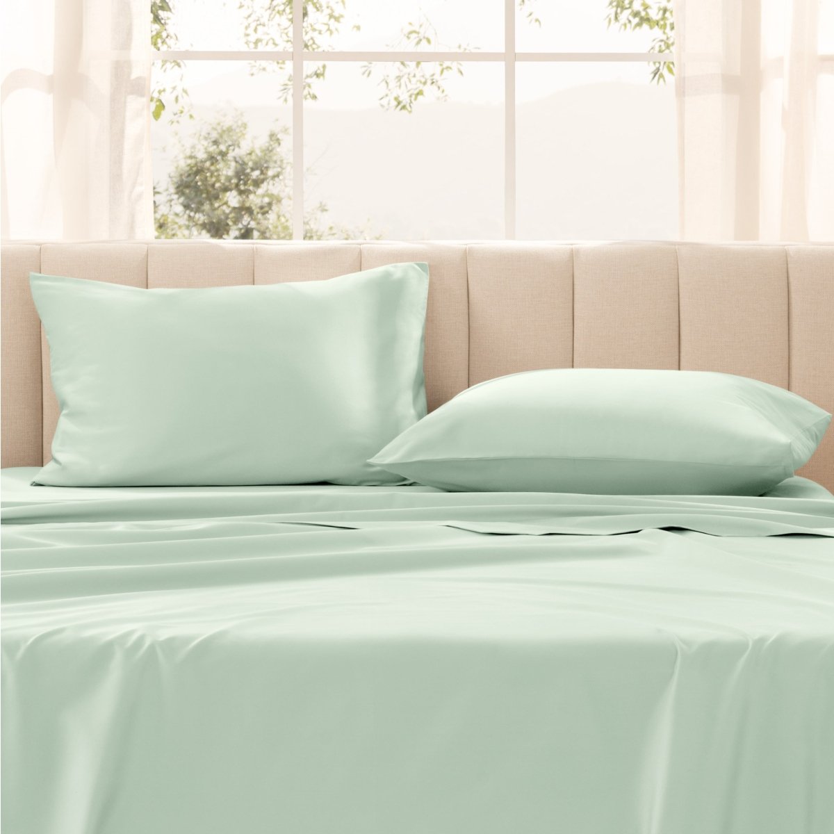 Pillows on a bed with in a bright room.