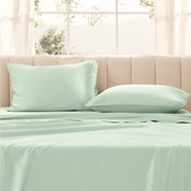 Pillows on a bed with in a bright room.