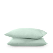 Two pillows stacked on a white background