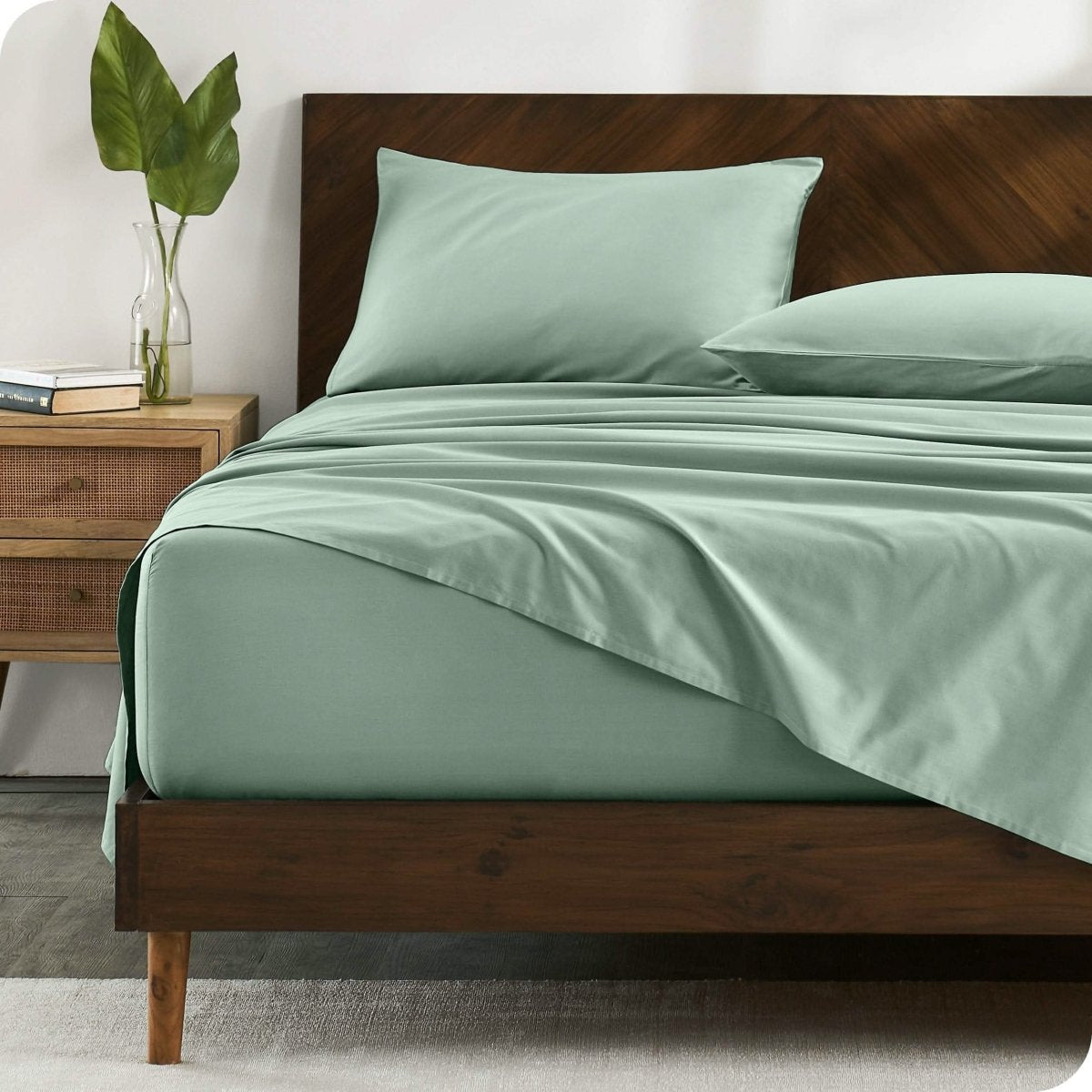 A bed made with organic cotton sateen sheets