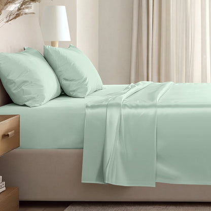 Sateen sheet set on a bed in a softly lit bedroom.
