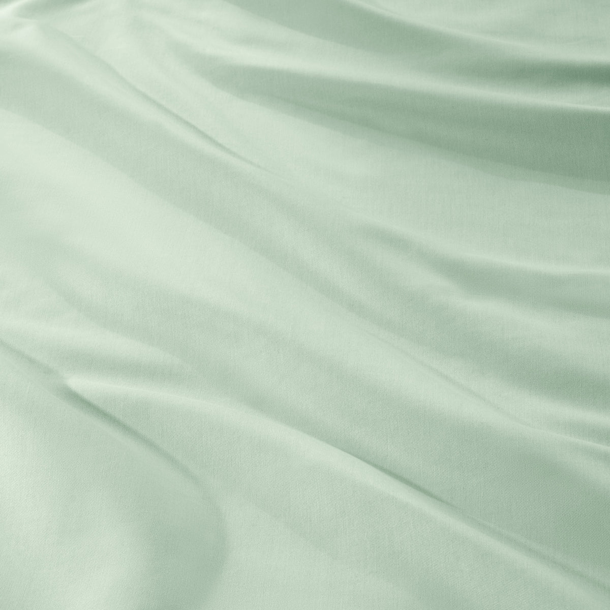 A close-up of draped sateen fabric with soft folds and a smooth texture.
