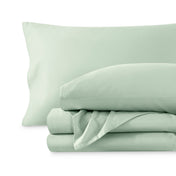 A sateen sheet set folded and stacked on a white background.