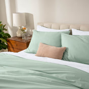 Bed with percale bedding in a bedroom setting