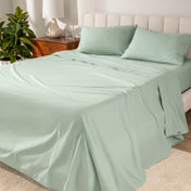 Percale sheets on a bed with a cream colored frame and headboard
