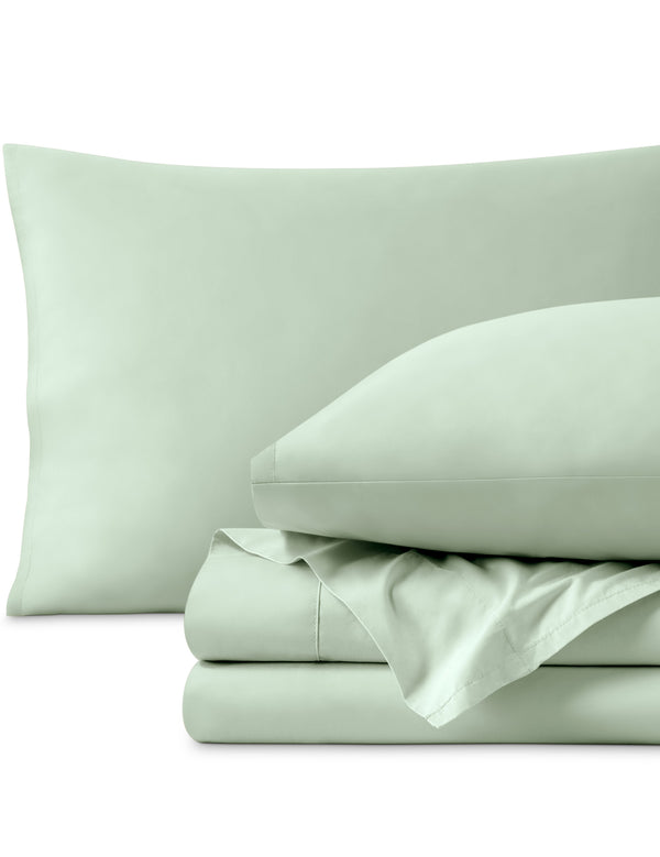 Percale sheets folded and matching pillowcases with pillows in them
