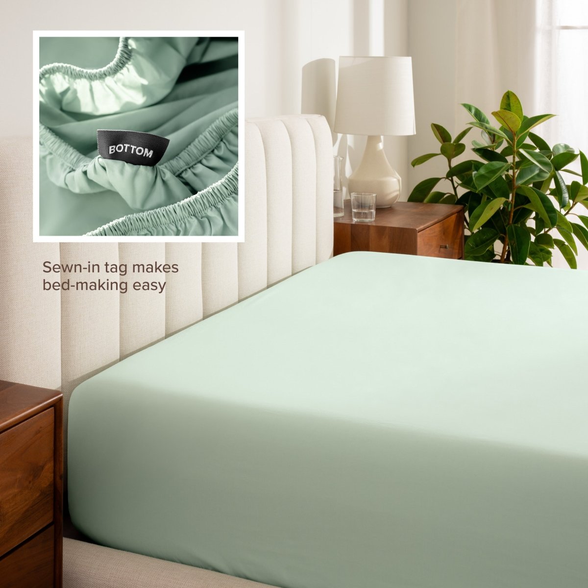 Fitted sheet on a bed with a close-up of a sewn-in tag that shows which side is the bottom.