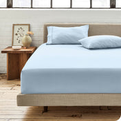 Modern bedroom with bed showing winter blue percale fitted sheet