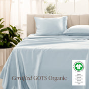 Bed with sateen bedding and pillowcases, featuring a GOTS Organic certification label.