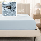 Bed with a fitted sheet next to a nightstand in a bedroom setting