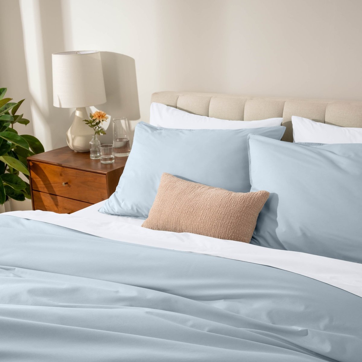 Bed with percale bedding in a bedroom setting